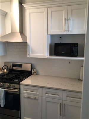 Kitchen in manhattan after white shaker cabinet with white cararra quartz